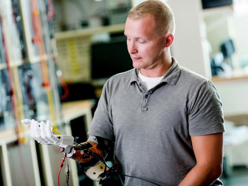 Disabled veteran wearing prosthetic hand developed by engineering graduate student.