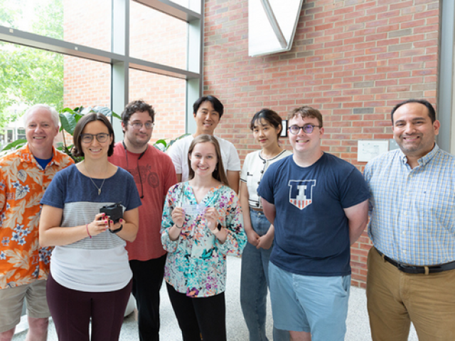 From left: Brian Cunningham, Amanda Bacon, Aaron Jankelow, Katherine Koprowski, Han Keun Lee, Weijing Wang, Robert Stavins, and Enrique Valera. Bacon and Koprowski are holding the instrument and the cartridge, respectively.